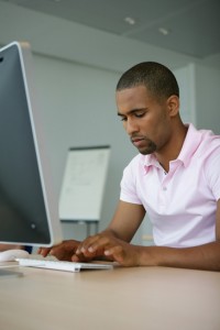 Man typing at computer